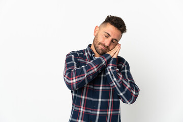 Caucasian man isolated on white background making sleep gesture in dorable expression