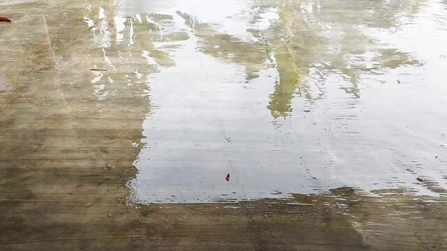 The cement plaster floor is wet from rainwater