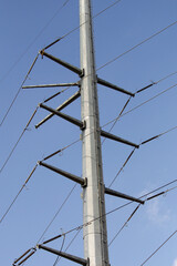 Powerline cables over the blue sky