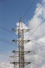 Powerline cables over the blue sky