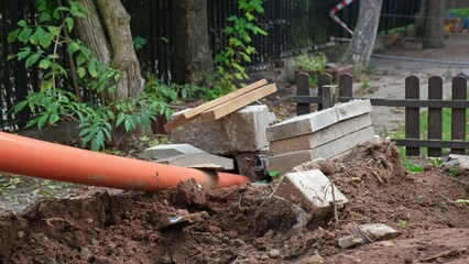 Plastic Gutter and Concrete Slabs Blocks Construction Materials Stored Outdoors during House and Garden Renovation