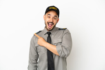 Young security  caucasian man isolated on white background surprised and pointing side