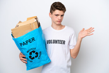 Teenager Russian man holding a recycling bag full of paper to recycle isolated on white background having doubts while raising hands