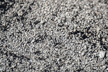 blend of granite gravel scattered over tar, symbolizing the intricate process of road repair, where craftsmanship meets resilience in urban infrastructure
