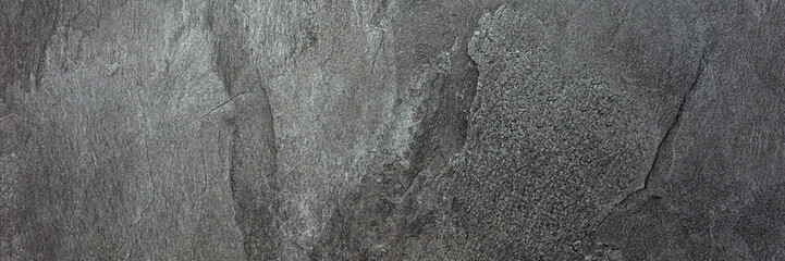 Panoramic image. Black gray uneven stone background