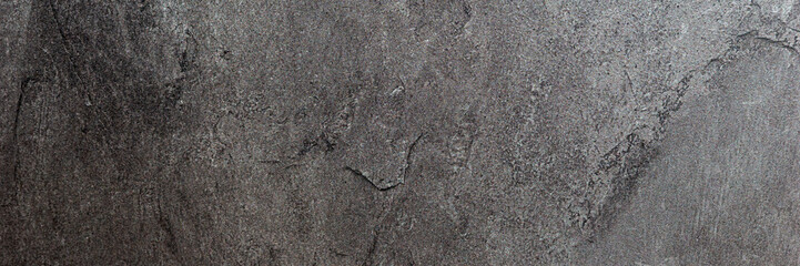 Panoramic image. Black gray uneven stone background