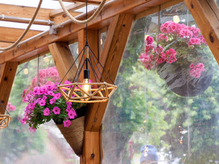 Cozy Wooden Gazebo with Pink Flowers and Geometric Lamp in Daylight