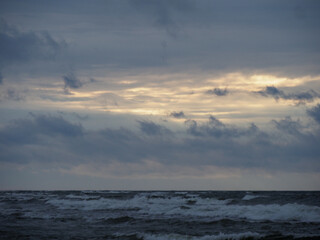 Sea During Stormy Dawn-Dusk with Dramatic Sky and Glimpses of Light