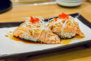 Burned salmon sushi with cheese