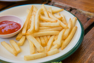french fries on plate with tomato sauce