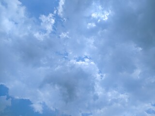 Bright, sun-drenched sky with fluffy white clouds. Perfect day for outdoor activities.
