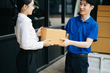 Express Delivery Service. Asian Courier Delivering Package to man Delivery service near van outside the warehouse, delivery home