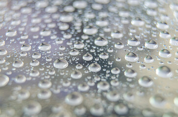 Macro view of raindrops on a transparent window. Rain droplet concept