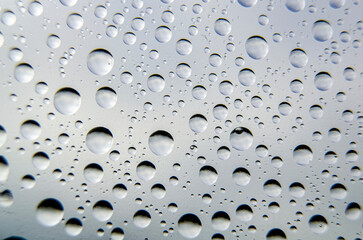 Top view of rainwater droplets on clear plastic. Fresh rain concept