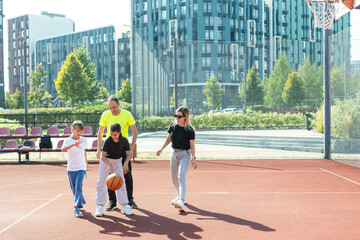 Time for family basketball. Family at basket playground. 