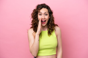 Young caucasian woman isolated on pink background with surprise and shocked facial expression