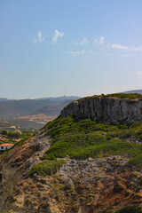 Rocky Cliff with Lush Green Shrubs Sardinia