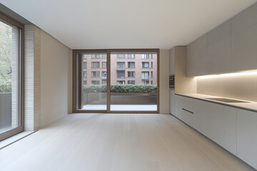 Obraz premium Modern kitchen with large windows and minimalist design in a contemporary apartment interior
