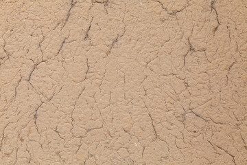 Clay plaster texture with straw as background.
