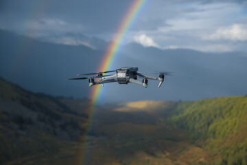 Fototapeta premium Drone taking photo of rainbow with a drone on high altitude grassland mountain top