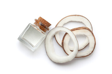 Top view of Fresh coconut fruit with coconut oil in a glass bottle. Isolated on a white background.