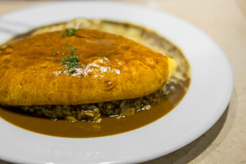 omu rice, omelette with rice with curry sauce. japanese food