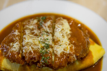 omu rice, omelette with rice with fried pork or tonkatsu, curry sauce. japanese food