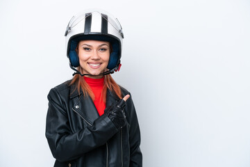 Young Russian girl with a motorcycle helmet isolated on white background pointing to the side to present a product