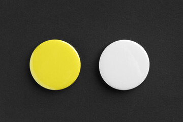 Button badges on black background, flat lay. Mockup for design