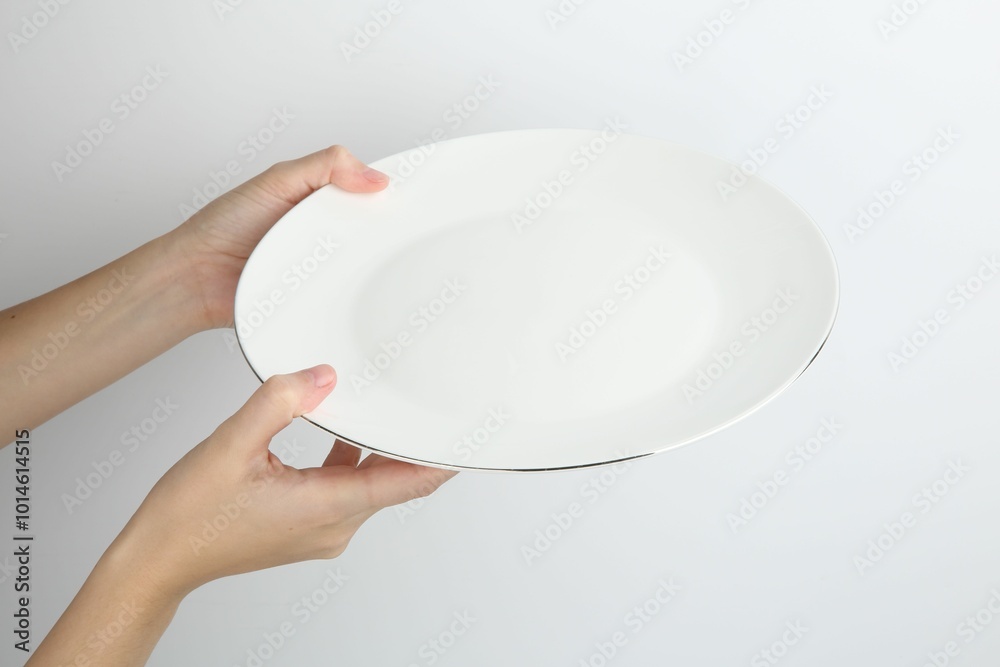 Sticker Woman with empty ceramic plate on white background, closeup