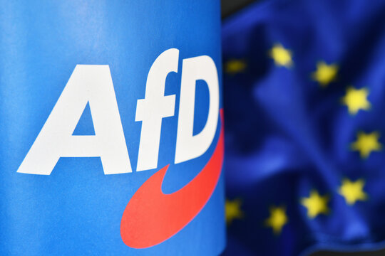 Burgdorf, Lower Saxony, Germany - April 23, 2024: Paper flag with the logo of  the right-wing political party Alternative for Germany, AfD, Flag of the European Union