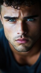 Fototapeta premium Portrait of an athletic and handsome man with striking blue eyes indoors