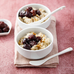 Homemade pudding with warm cherries and coconut