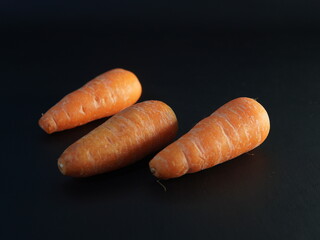 carrots. some carrots on a black background