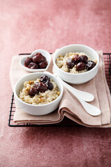 Homemade pudding with warm cherries and coconut