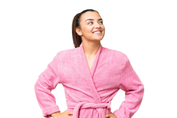 Young woman in a bathrobe over isolated chroma key background posing with arms at hip and smiling