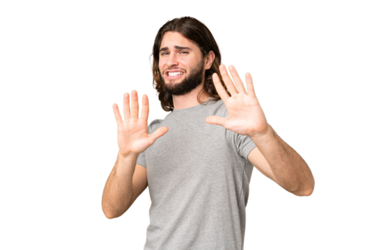 Young handsome man over isolated chroma key background nervous stretching hands to the front
