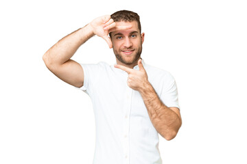 Fototapeta premium Young handsome blonde man over isolated chroma key background focusing face. Framing symbol