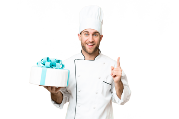 Young handsome blonde man with a big cake over isolated chroma key background pointing up a great idea