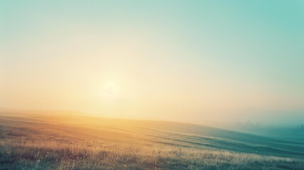 Obraz premium A warm dawn greets an expansive field with a dreamy blend of golden hues, inviting over the horizon of gently rolling hills.