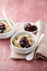 Homemade pudding with warm cherries and coconut