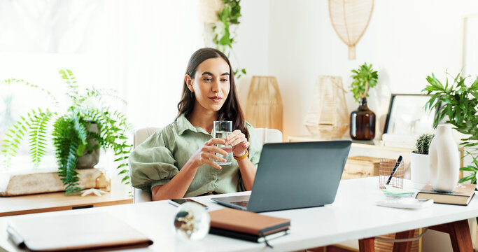 Water, glass and woman at laptop in home office for research, review and business plan for freelance project. Remote work, relax and consultant at desk with drink, computer and reading online article - Powered by Adobe