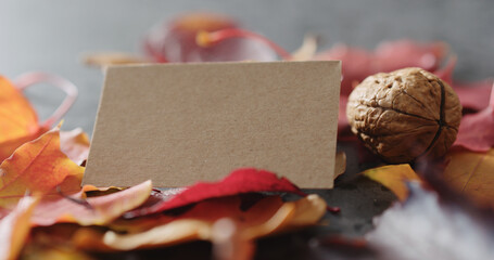 composition with autumn leaves with paper card