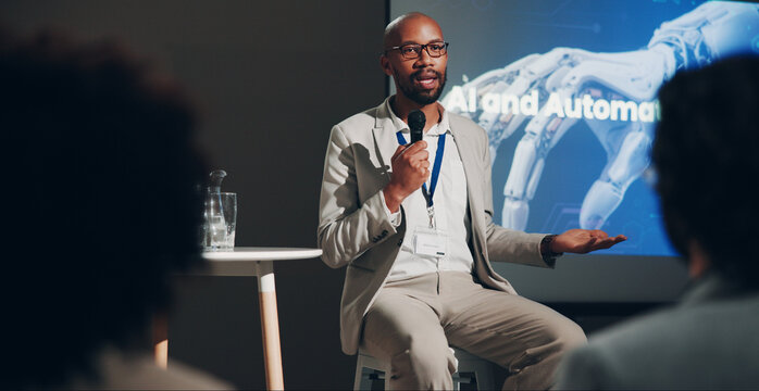 Black man, stage and microphone at conference for technically and AI discussion as public speaker. Male person, screen and presentation for global networking, seminar and summit in auditorium
