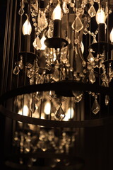 A detailed view of a decorative chandelier with light sources, useful for interior design and...
