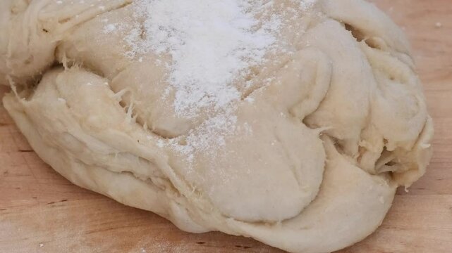 Mixing flour with egg, close-up, on a black background. Preparing the dough.