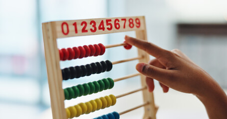 Hand, abacus and child learning math for brain development, study or arithmetic. Kid, person and...