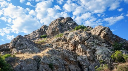 Fototapeta premium Rocky outcrop on a hilltop, with rugged terrain and sharp angles carved by nature