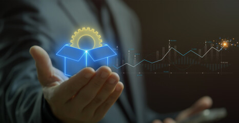 Product Development concept, process of strategizing, brainstorming, planning, building, releasing a product to market. Businessman shows glowing neon line of gear icon inside box on virtual screen.