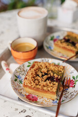 dessert and coffee for two. nut cake with pieces of pistachios and coffee on the table in an open-air cafe.